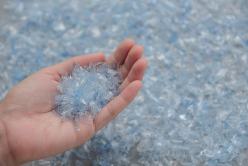 Woman hand holding Bottle flake,PET bottle flake,Plastic bottle crushed,Small pieces of cut blue plastic bottles; Shutterstock ID 1191663625; purchase_order: -; job: -; client: -TSL_HBC_LPstabilimento-2022_11_09; other: -